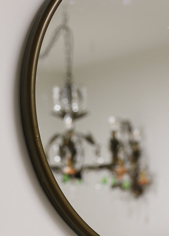 Iron Framed Round Mirror in Antique Brass Finish